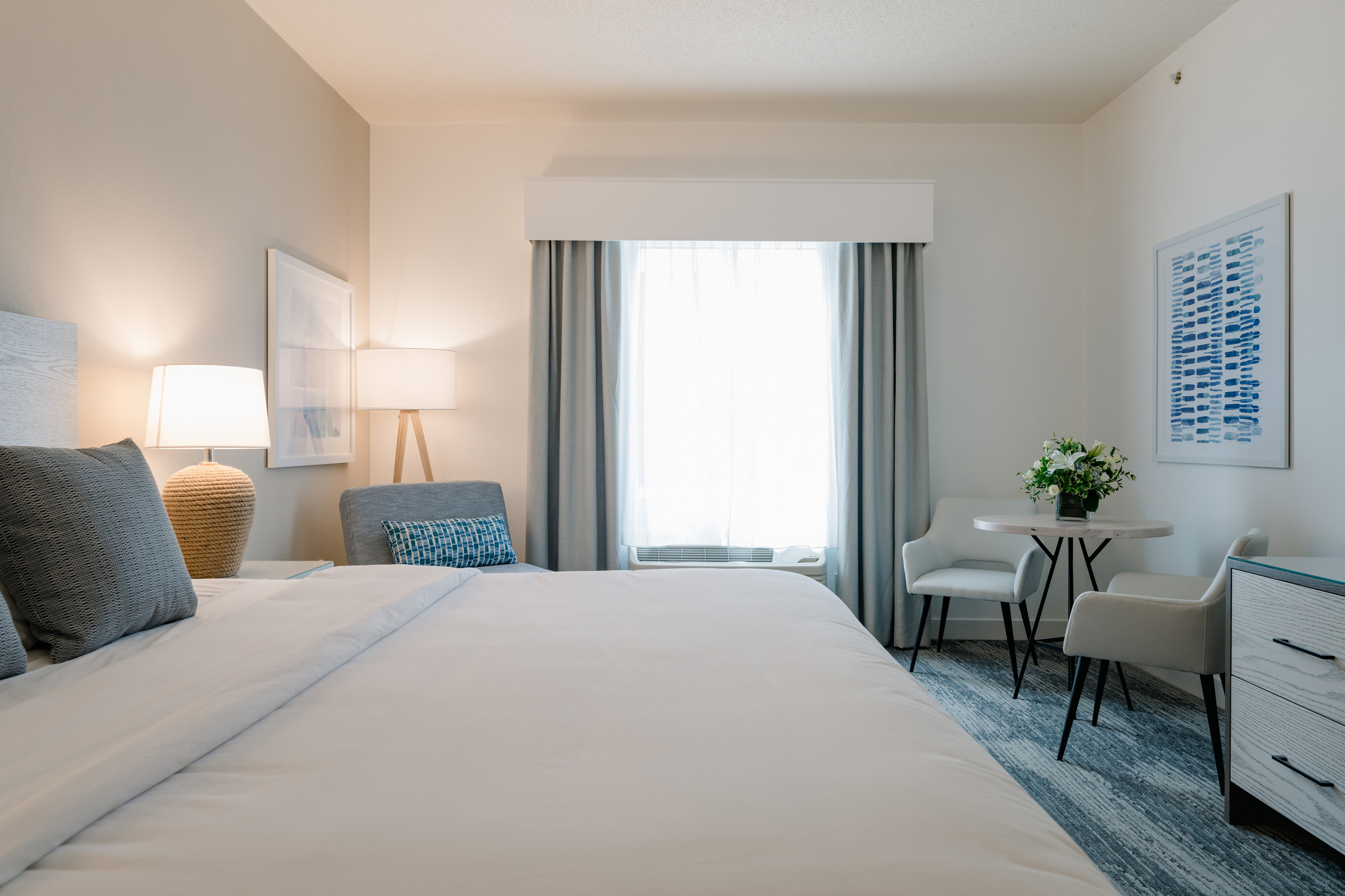 King room with seating area and bright window.