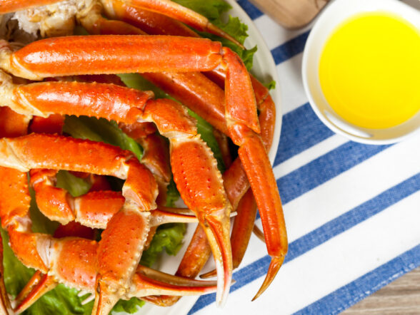Plate of crab legs with melted butter.