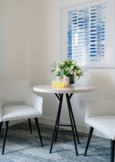 Small table with flowers and drinks in modern room.