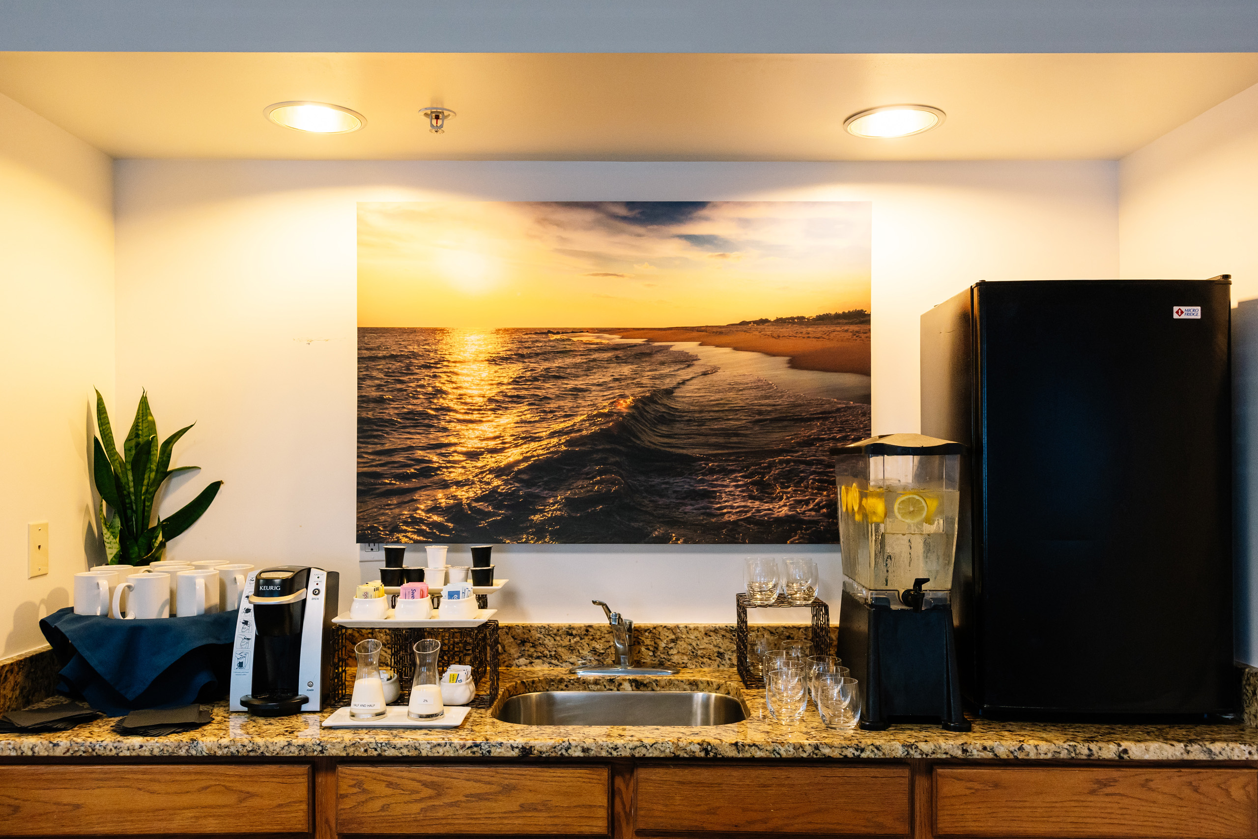 Coffee and beverage station with ocean photo backdrop.
