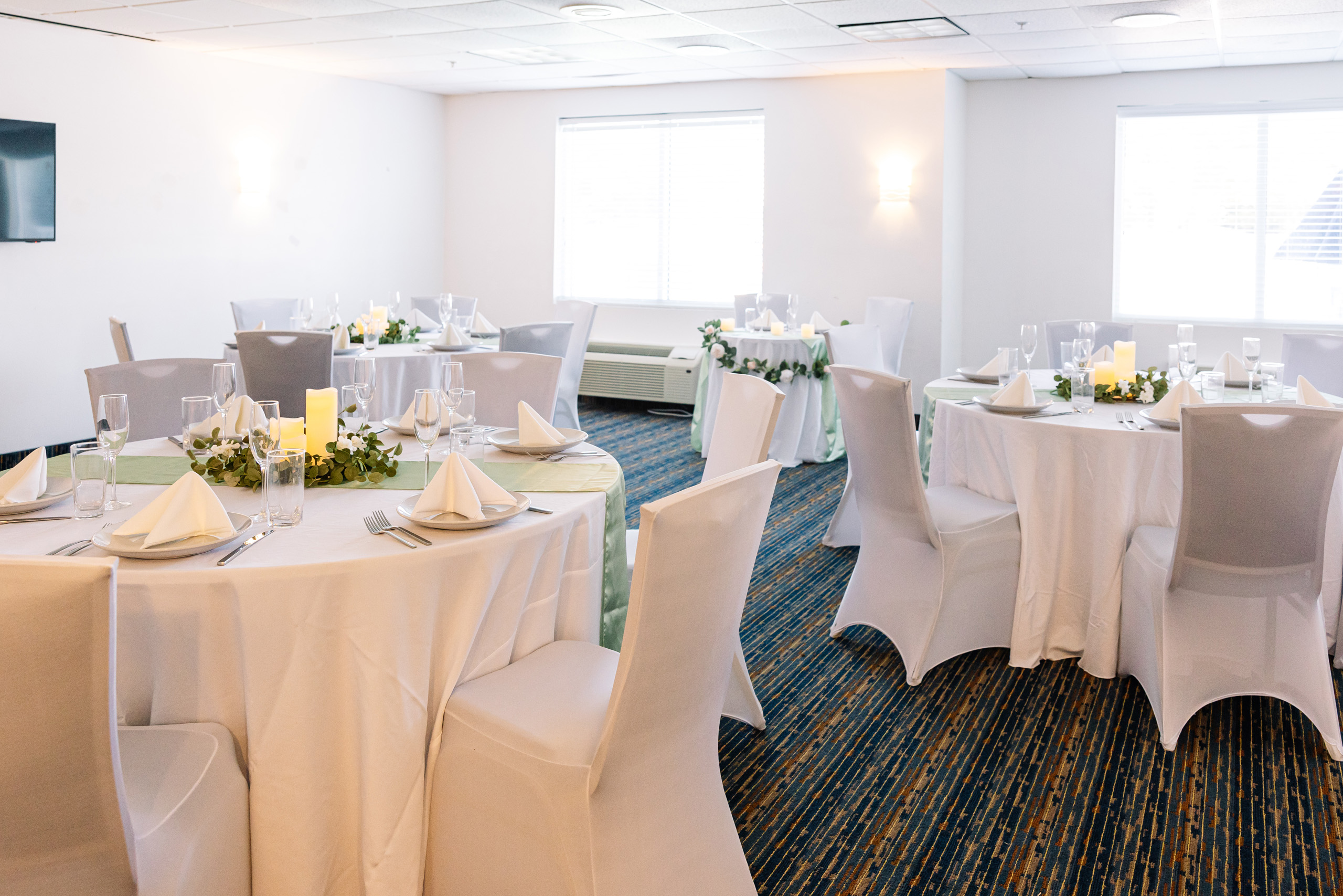 Event room with round tables set for reception.