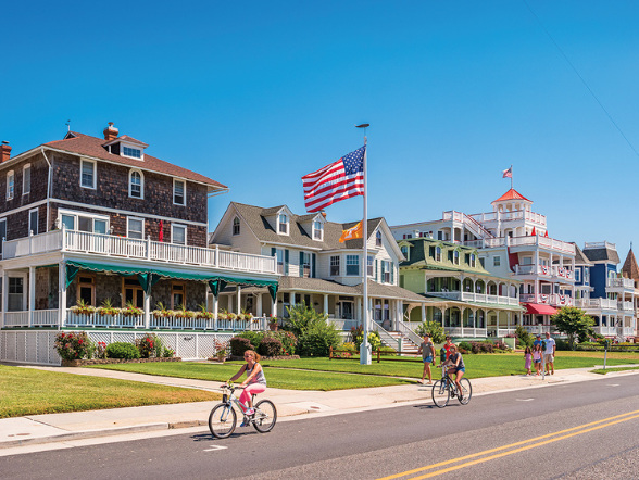 Cape May New Jersey with cyclers biking by houses