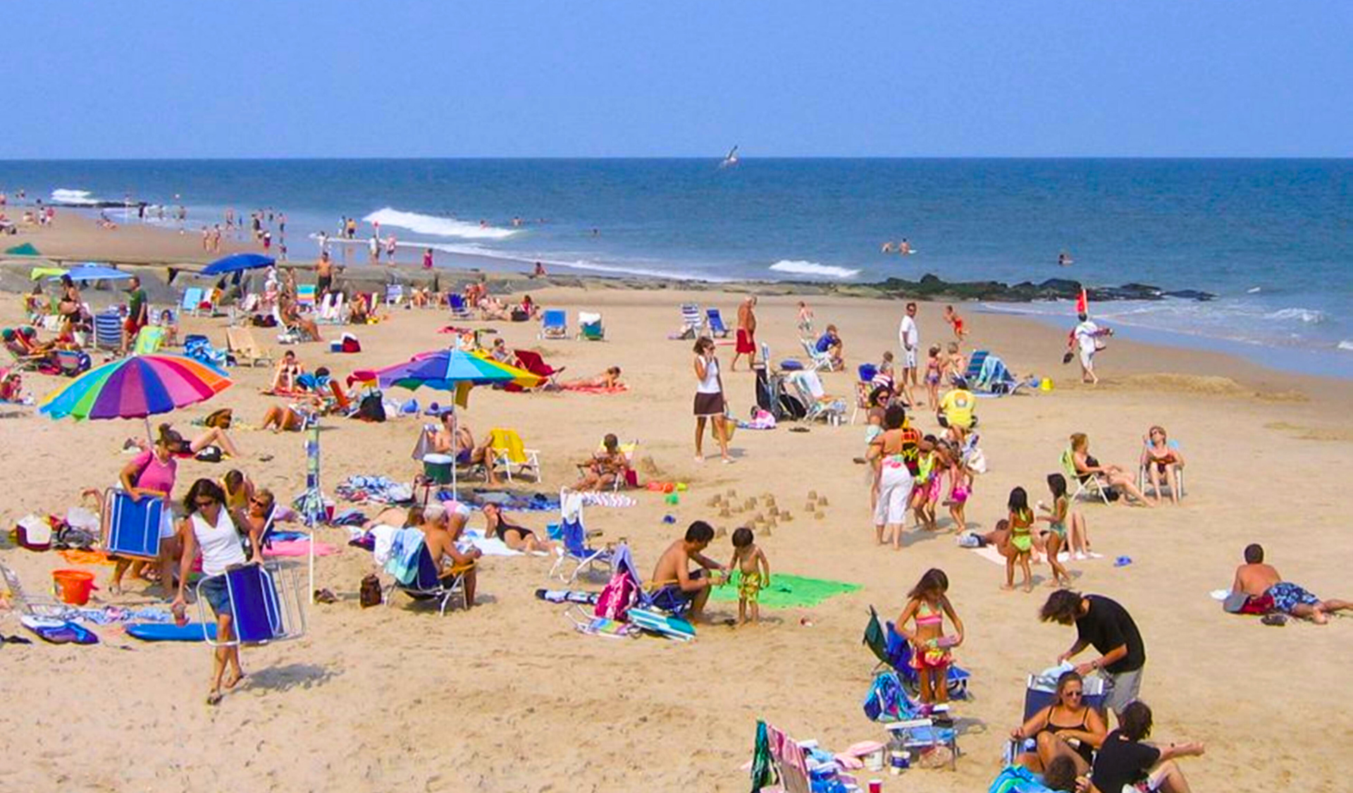 Crowded beach of people and umbrellas
